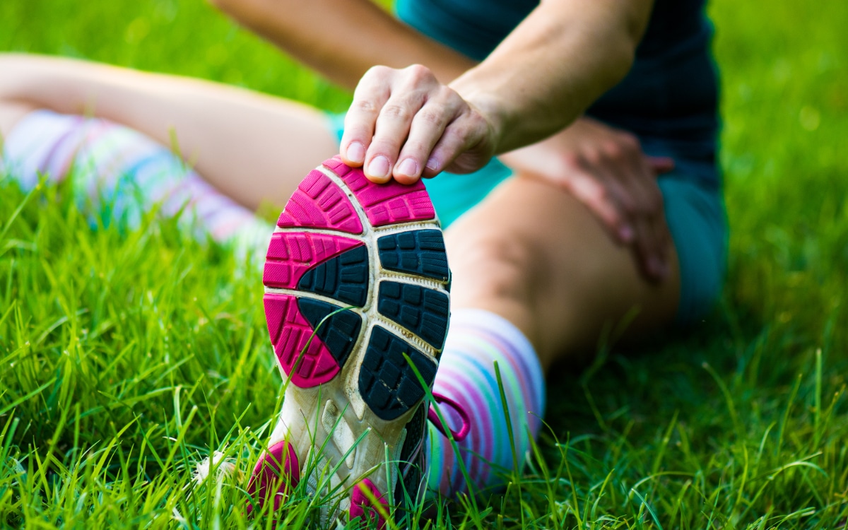 fitt girl getting streching her legs before running outdoors